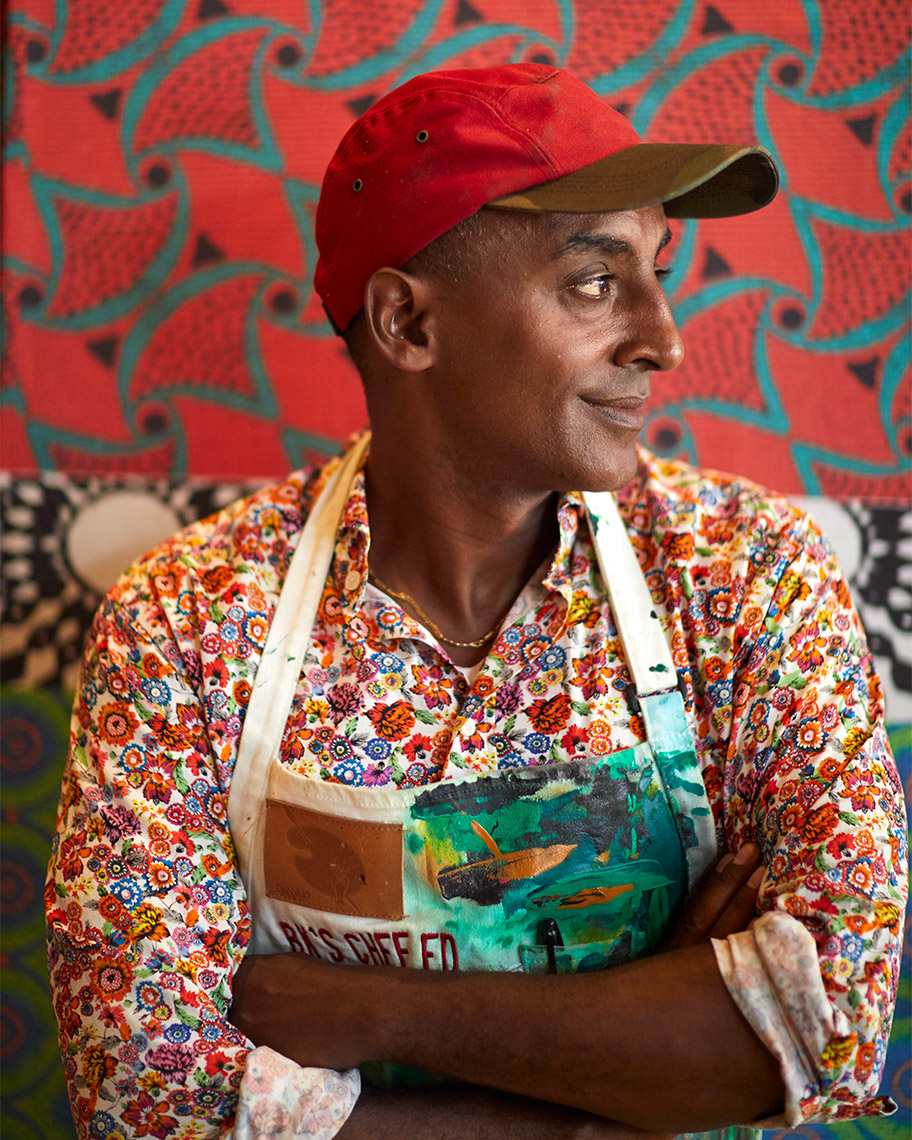 Famous chef, Marcus Samuelsson at his Harlem restaurant, Red Rooster. A portrait in bold patterns by Lucy Schaeffer