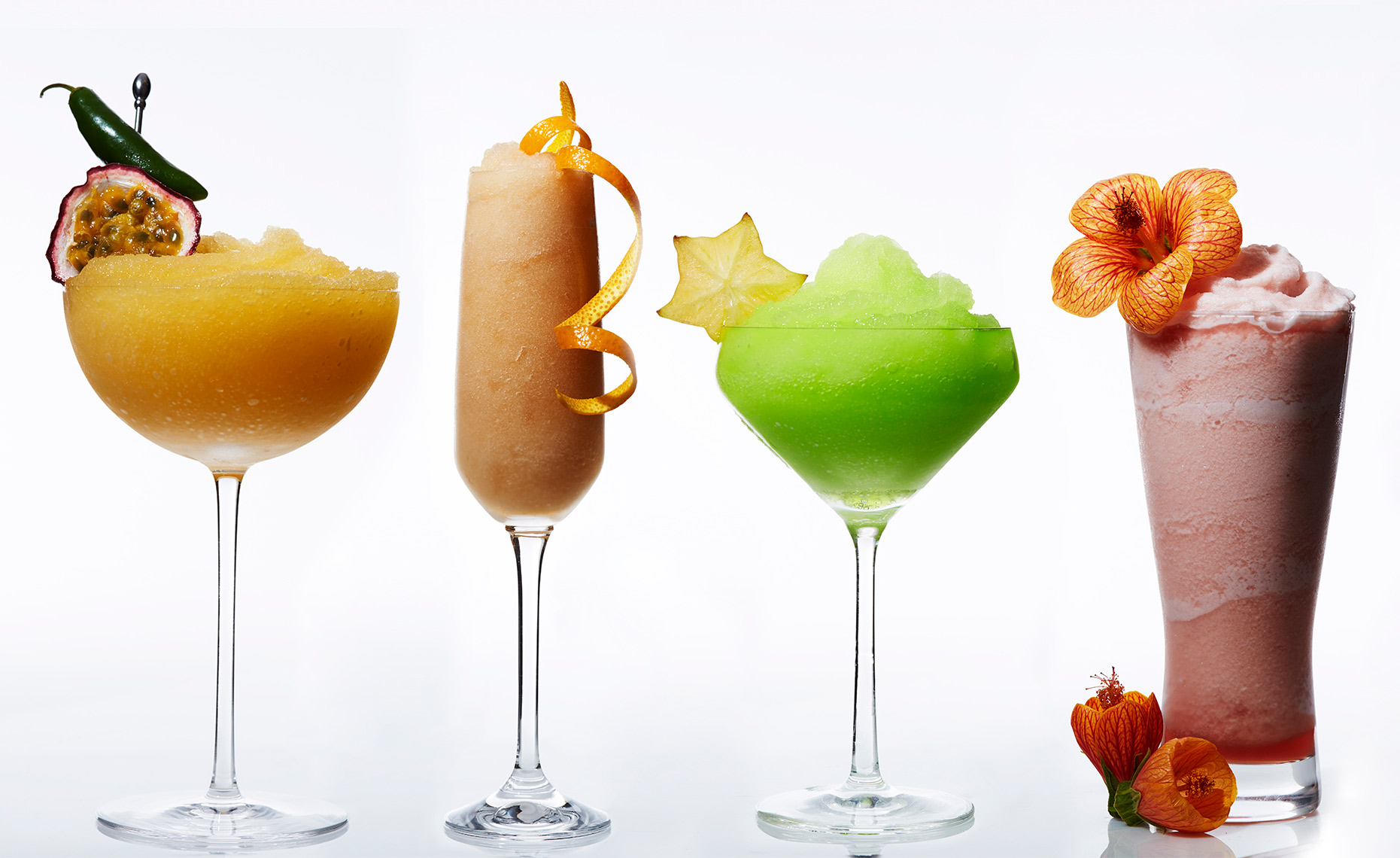 Colorful frozen cocktails shot in a row against white in the studio.